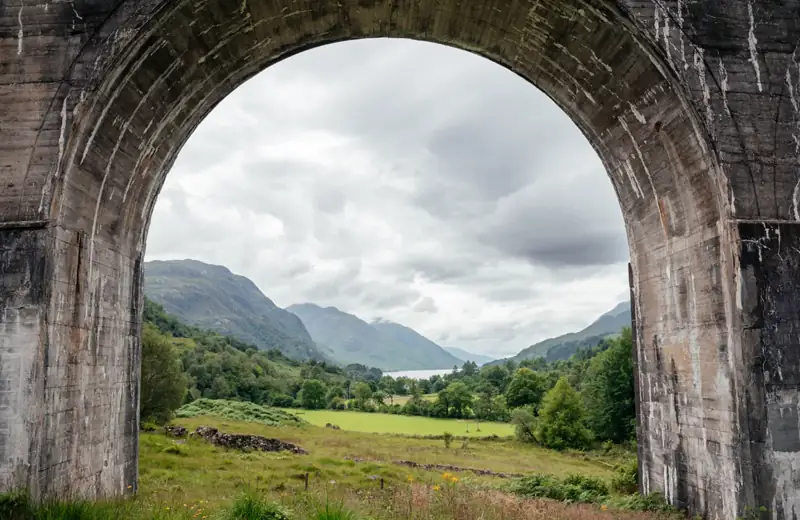 View through a Glenfinnan Viaduct arch to Loch Shiel and the glen