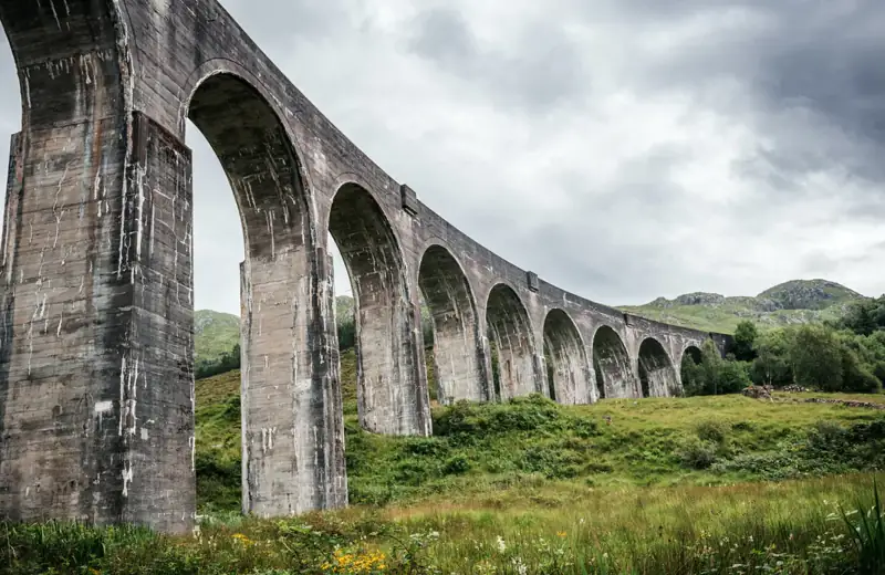 Low-angle view along the concrete arches of the Glenfinnan Viaduct