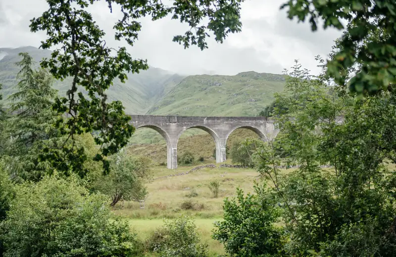 The Glenfinnan Viaduct framed by Highland woodland
