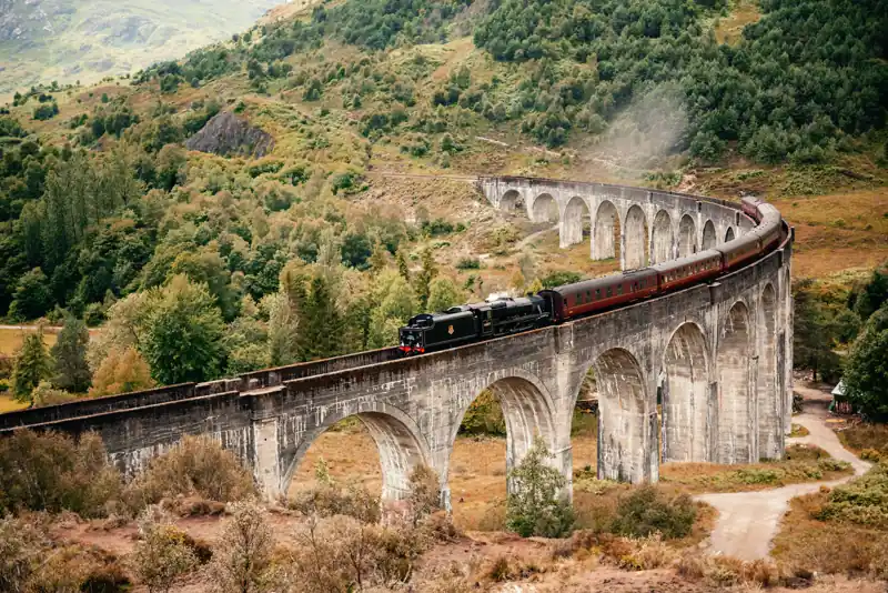 Jacobite steam train curving across the full Glenfinnan Viaduct